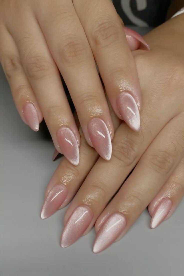 Soft pink chrome almond nails with a pearl sheen